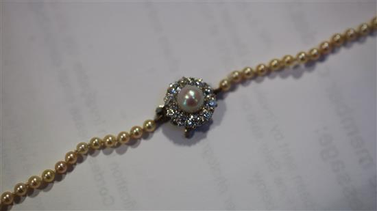 A mid 20th century single strand cultured pearl necklace with diamond and pearl set white gold clasp & pr of earclips.
